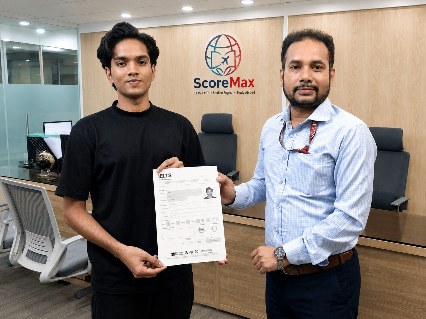 ScoreMax student with an instructor holding an IELTS result in the ScoreMax office